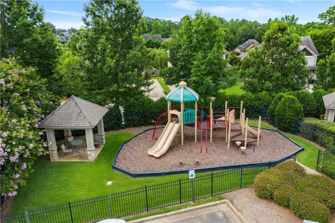 A dedicated recreational area for residents, featuring a charming gazebo alongside a vibrant playground with slides and climbing structures.