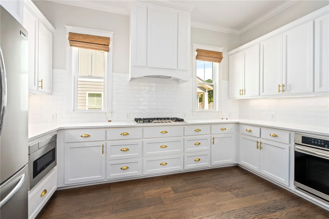 The upscale kitchen steals the spotlight with its stunning cabinetry and finishes.