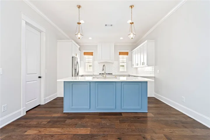 The upscale kitchen steals the spotlight with its stunning cabinetry and finishes.