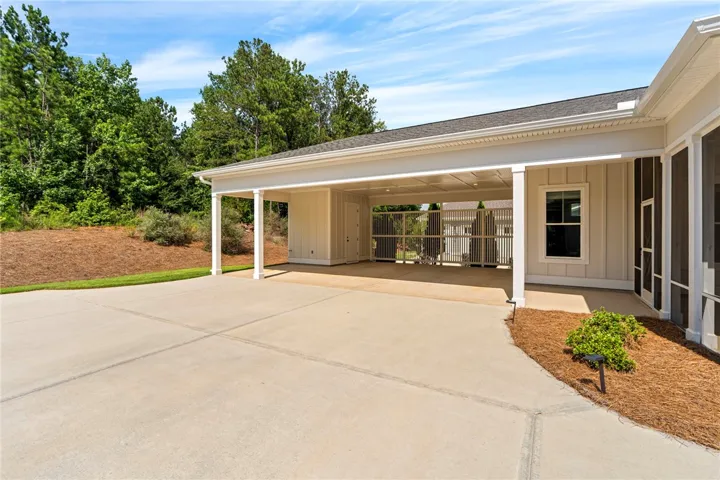 Two car carport offers additional space for golf cart parking plus a storage closet.