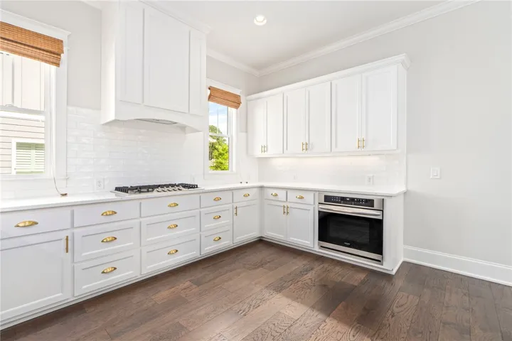 The upscale kitchen steals the spotlight with its stunning cabinetry and finishes.