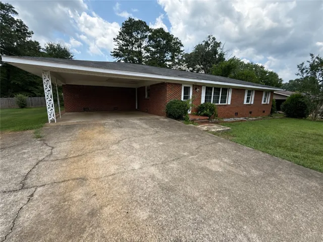 A well-maintained brick ranch home with a spacious carport awaits.