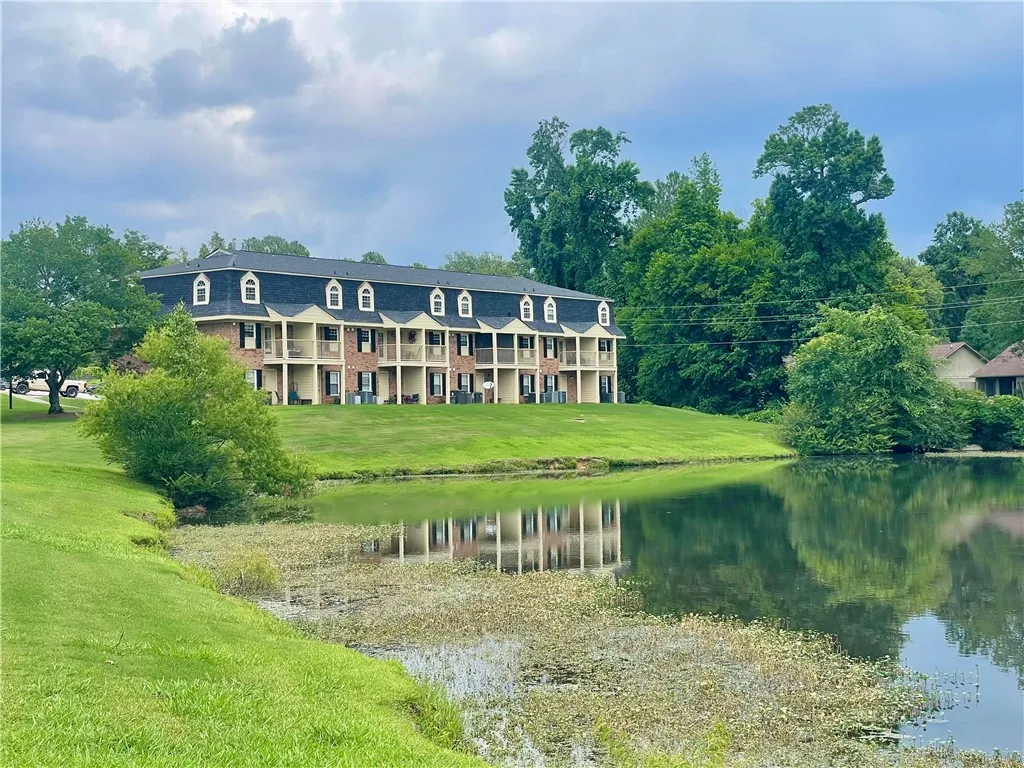 Lakeside living defines this picturesque multi-unit residence, offering serene water views and verdant surroundings.