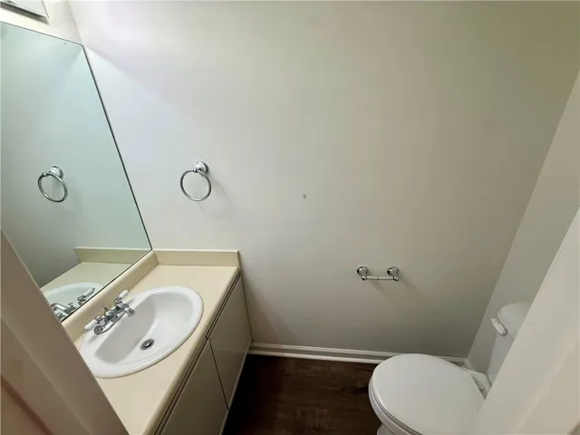 A compact and functional half bathroom features a well-maintained vanity and clean fixtures.
