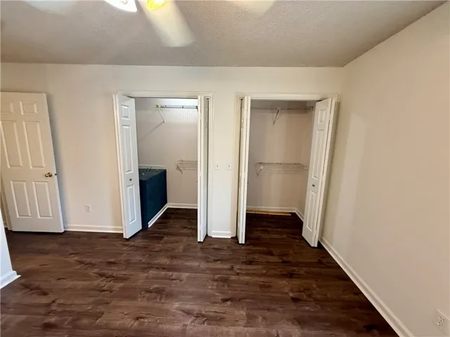 Ample storage options are available in this room, featuring two separate closet spaces with wire shelving.