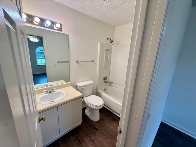 Functional bathroom featuring a vanity with ample counter space and a classic tub/shower combination.