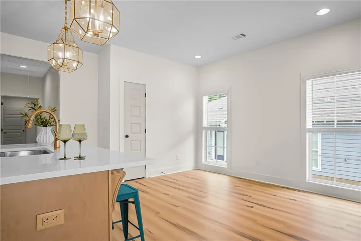 A versatile kitchen island offers an integrated sink, perfect for culinary endeavors and entertaining.