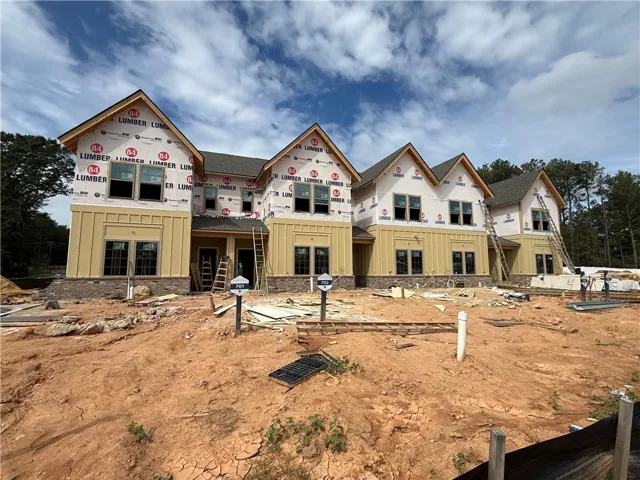 New multi-family construction progress highlights gabled rooflines and classic siding details.