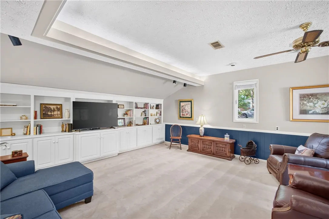 Integrated wall unit and custom ceiling detail define this inviting living area.
