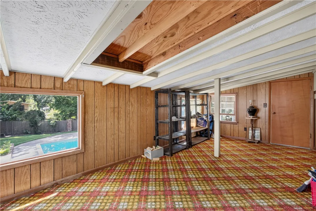 A versatile bonus room awaits, offering ample space and a refreshing pool view.