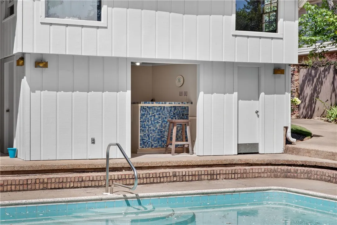 An inviting poolside bar, ready for entertaining, completes this sun-drenched outdoor oasis.