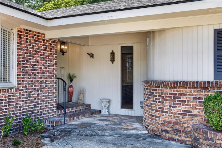 A welcoming front entrance featuring rich brickwork and inviting stone steps.