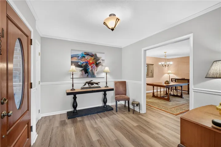 A welcoming entryway with durable flooring transitions seamlessly into an inviting dining area.