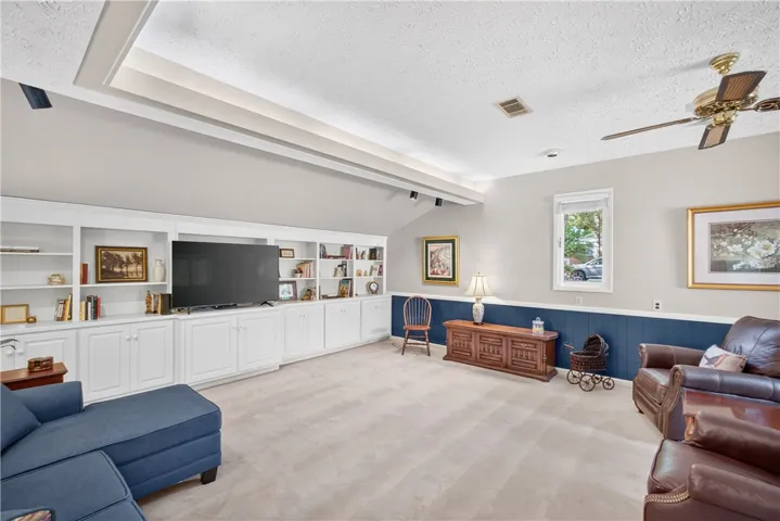 Integrated wall unit and custom ceiling detail define this inviting living area.