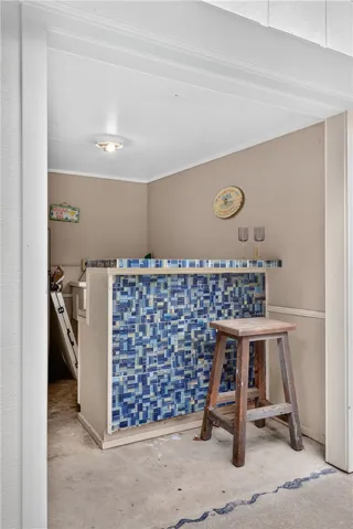 A stylish bar area features a mosaic tile facade, perfect for entertaining.