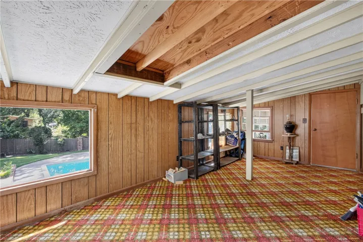 A versatile bonus room awaits, offering ample space and a refreshing pool view.