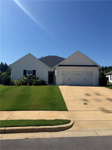A classic facade with a welcoming entry and an attached garage awaits.