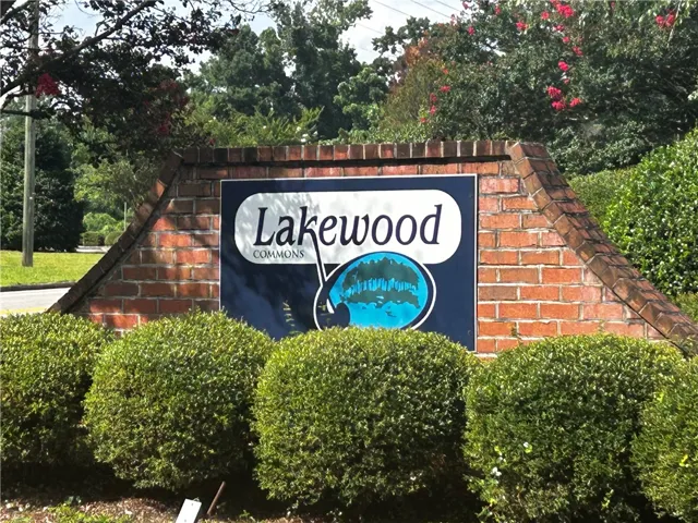 A welcoming brick sign framed by lush landscaping greets residents to Lakewood Commons.