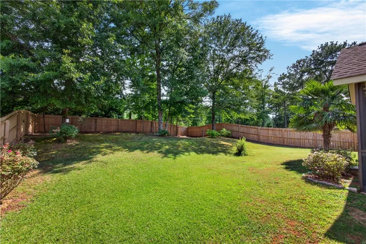 A well-maintained fenced backyard offers ample space for outdoor enjoyment and privacy.