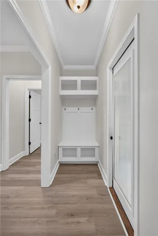 A well-appointed coat nook features a built-in bench with hooks and cubbies for convenient storage.
