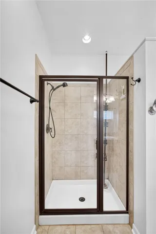 A well-appointed shower stall features tiled walls and a glass enclosure, offering a refreshing bathing experience.