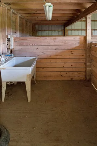 A well-equipped stable with a utility sink for equine care.
