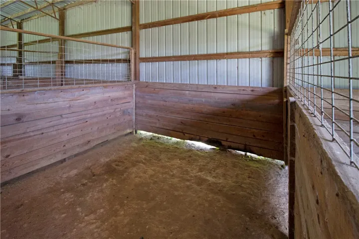 Functional barn stalls featuring sturdy wood and wire paneling, ready for livestock.