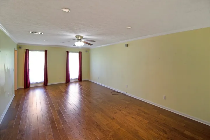 Hardwood floors and generous natural light define this inviting living area.
