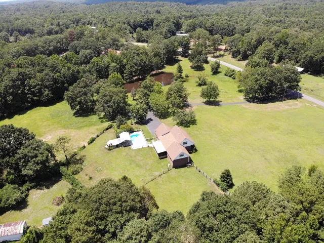 Discover a private retreat with a secluded pool and a serene pond, surrounded by verdant landscapes.