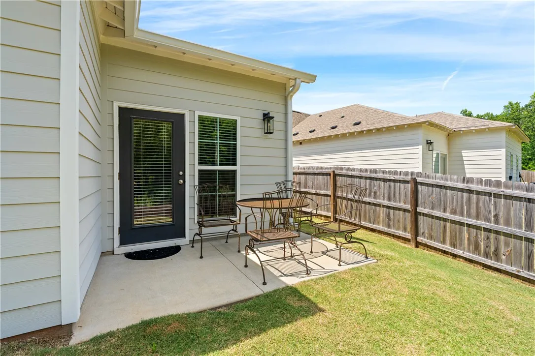 Covered patio and fenced backyard