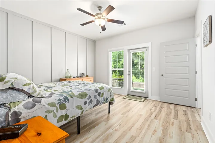 Primary Bedroom with accent wall and LVP floors