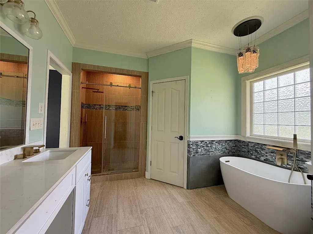 A spacious primary bathroom with a modern soaking tub, walk-in shower, and stylish fixtures.