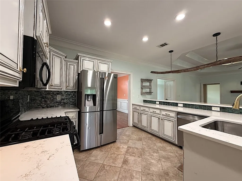 A gourmet kitchen offers stainless steel appliances and abundant counter space.