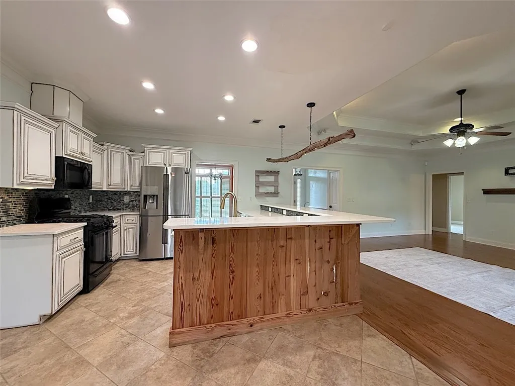 A well-appointed kitchen island with warm wood paneling creates a natural focal point within this open-concept living space.