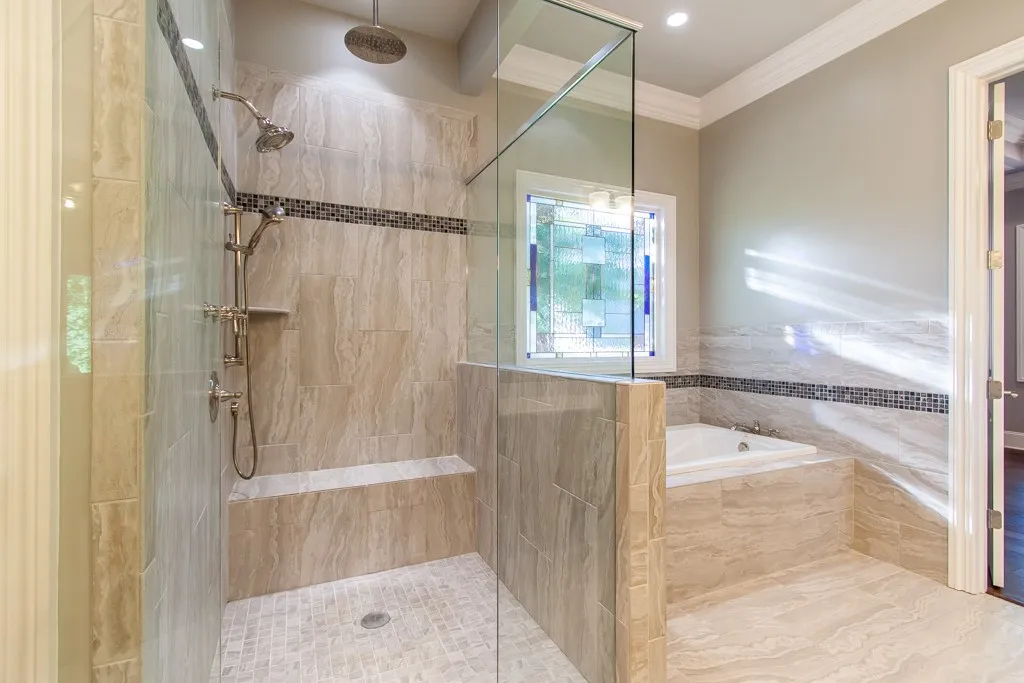 A spacious primary bathroom with a walk-in shower, soaking tub, and elegant tile work.