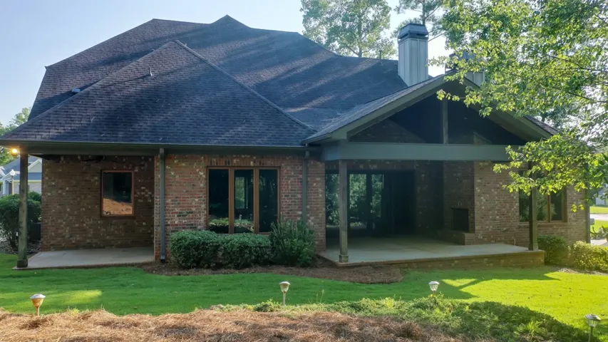 Brick exterior home with two covered patios offers serene outdoor living spaces.