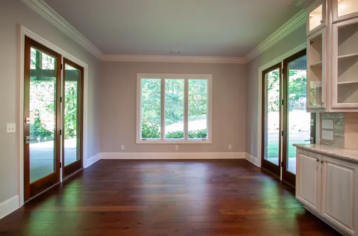 Breakfast Room featuring glass French doors and a wall of windows that invite the outdoors in.