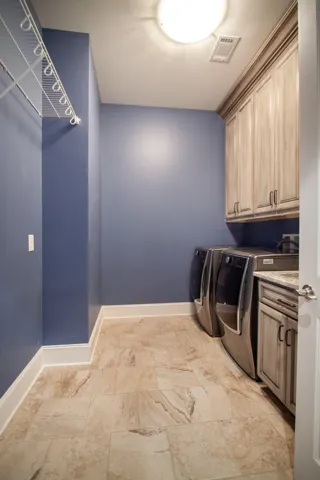 Functional and stylish, this dedicated laundry room features practical storage and separate sink.
