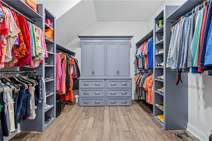 Primary closet. With Custom Cabinets.