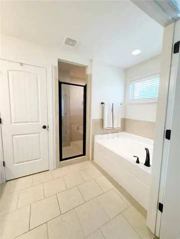 Spacious ensuite with separate tub and shower. The shower is huge!
