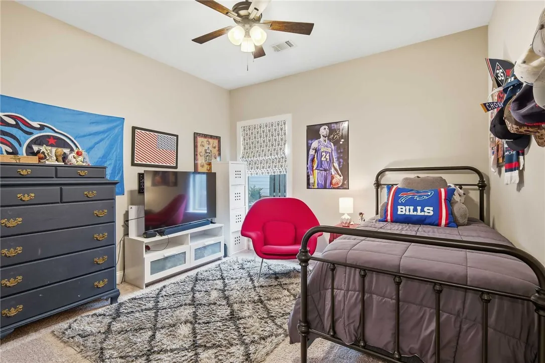 A well-lit bedroom provides ample space and comfort.