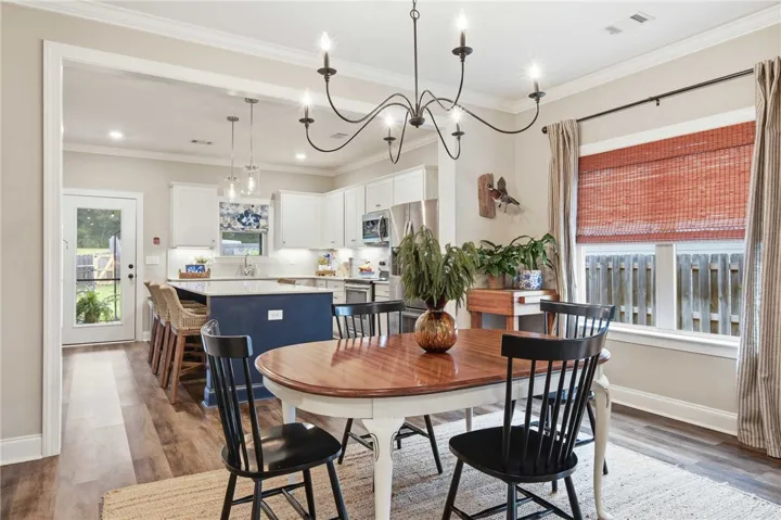 An inviting open-concept space features a well-appointed kitchen flowing seamlessly into a charming dining area.