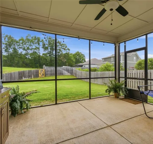 Enjoy outdoor living with a spacious screened-in patio and fenced private yard.