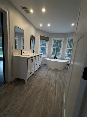 Luxurious bathroom with a freestanding tub and dual vanities, perfect for unwinding.