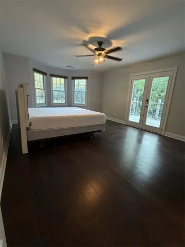 Hardwood floors and a private deck entry define this serene bedroom space.