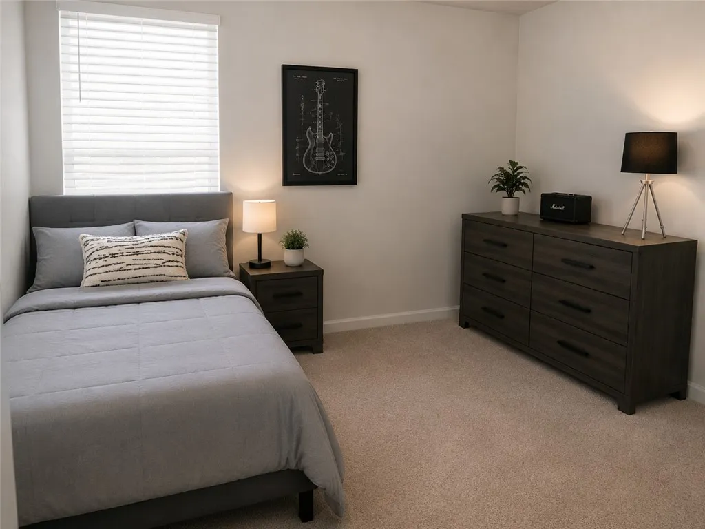 Well-lit and functional, this private bedroom offers carpeted flooring and abundant natural light.