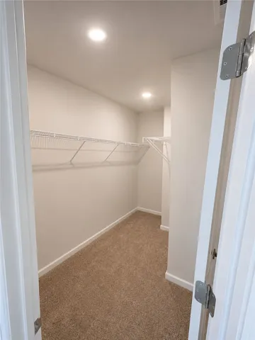 A well-lit, generous closet provides ample storage solutions.