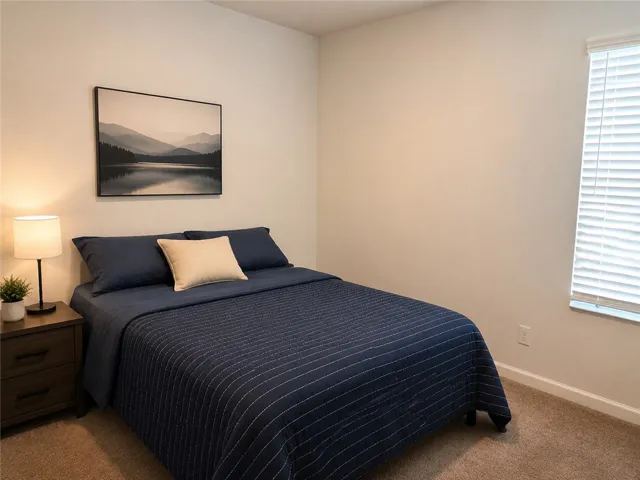A well-lit bedroom provides a serene retreat for quiet relaxation.