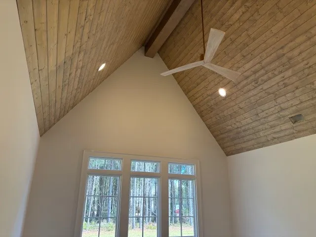 Vaulted wood plank ceilings highlight the airy design of this light-filled room.