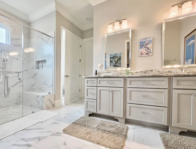Ensuite Bathroom boasts a zero entry shower w/bench, double vanity & private water closet
